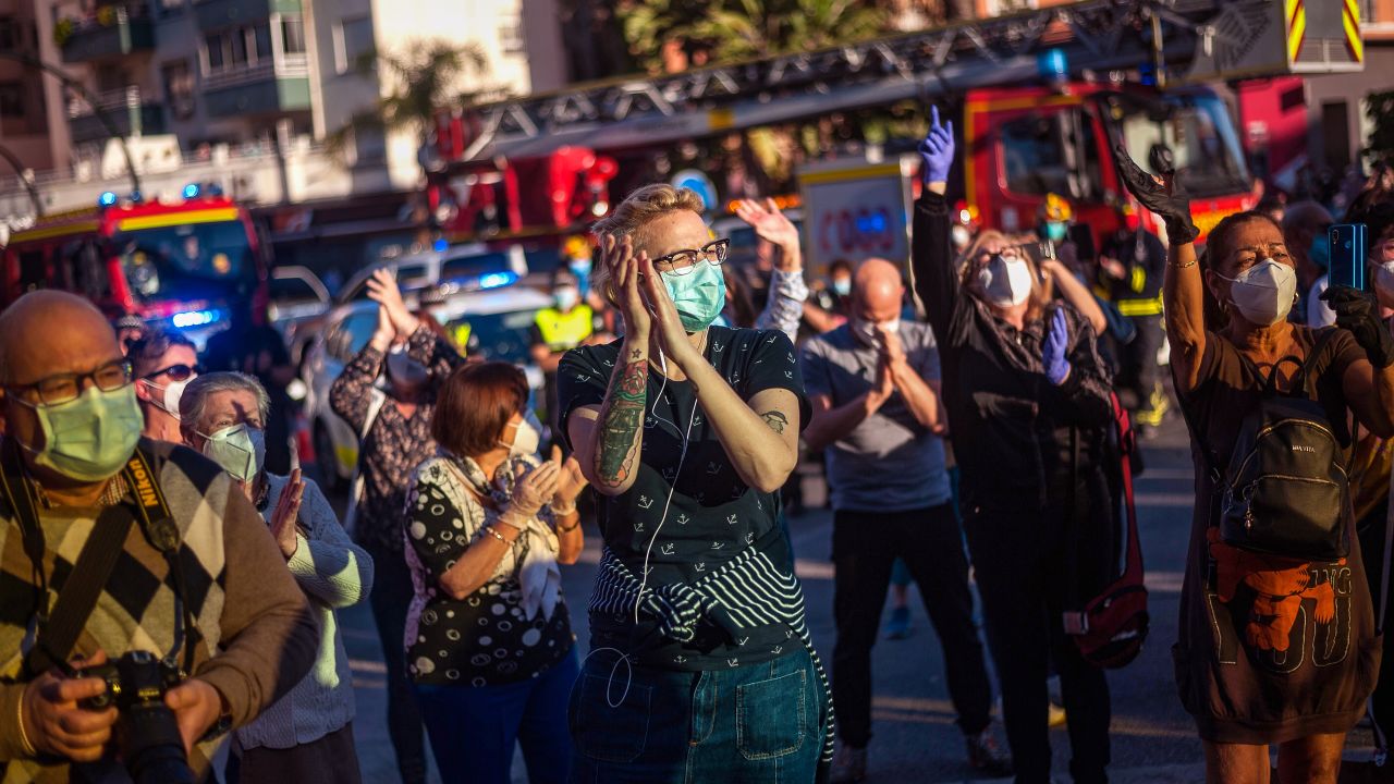People applaud health care workers outside the Regional Hospital in Malaga, Spain, on May 17, 2020, to show their gratitude during the partial lockdown in the country.