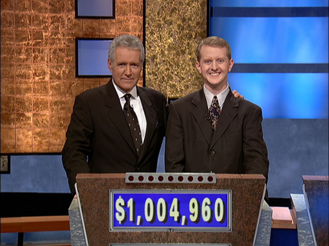 "Jeopardy!" host Alex Trebek (left) poses with contestant Ken Jennings (right) after his earnings from a record-breaking streak on the game show surpassed $1 million on July 14, 2004.  