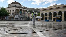 A municipal worker disinfects the empty Monastiraki square in central Athens. Greece, on the first day of a three-week lockdown in November.