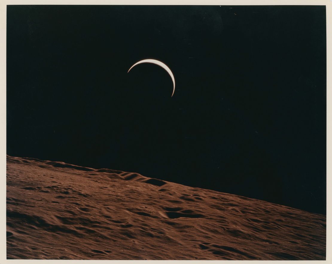 Crescent Earth rising beyond the Moon's barren horizon, taken in  1971.