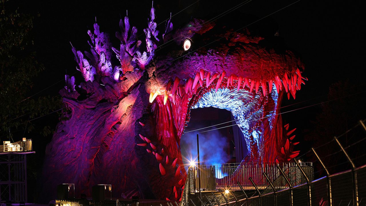 Bright lights illuminate the monster at night. 