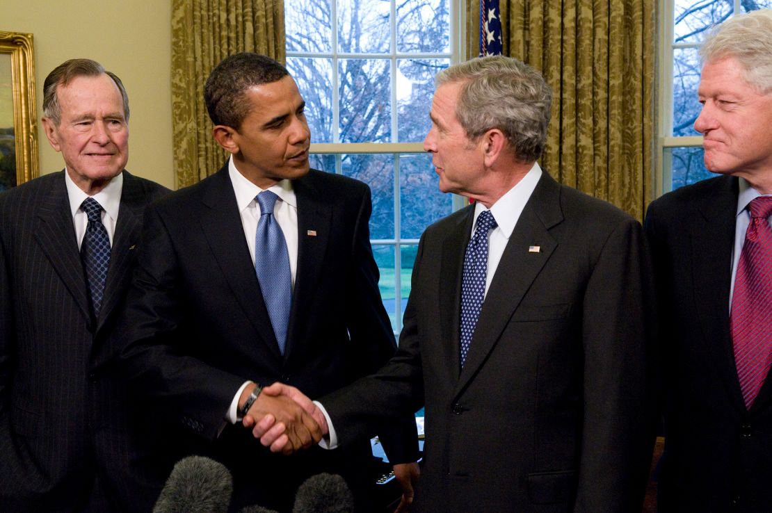 U.S. President George W. Bush shakes hands with President-elect Barack Obama, as former President Bill Clinton, and former President George H.W. Bush look on in the Oval Office January 7, 2009 in Washington, DC. (Photo by Ron Sachs-Pool/Getty Images)