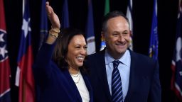 Democratic vice presidential running mate, US Senator Kamala Harris and her husband Douglas Emhoff pose on stage after the first Biden-Harris press conference in Wilmington, Delaware, on August 12, 2020. 