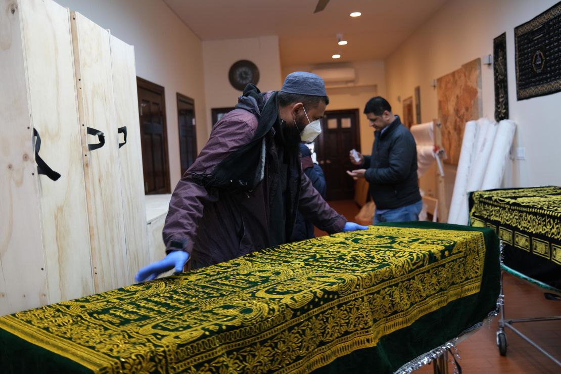 A casket of a Muslim man who died from what was believed to be the coronavirus is prepared for burial at a busy Brooklyn funeral home on May 9, 2020.