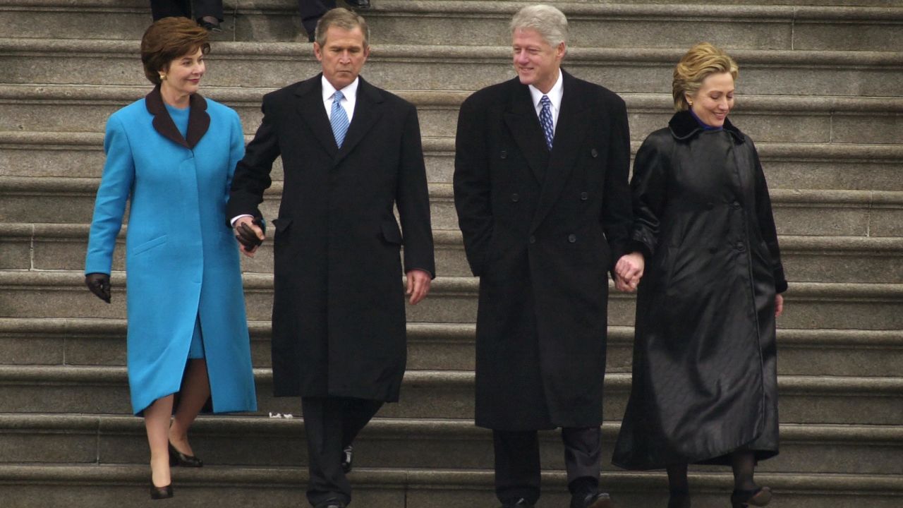 President George W. Bush, first lady Laura Bush and former President Bill Clinton and first lady Hillary Rodham Clinton exit the Capitol building following the presidential inauguration ceremony January 20, 2001.