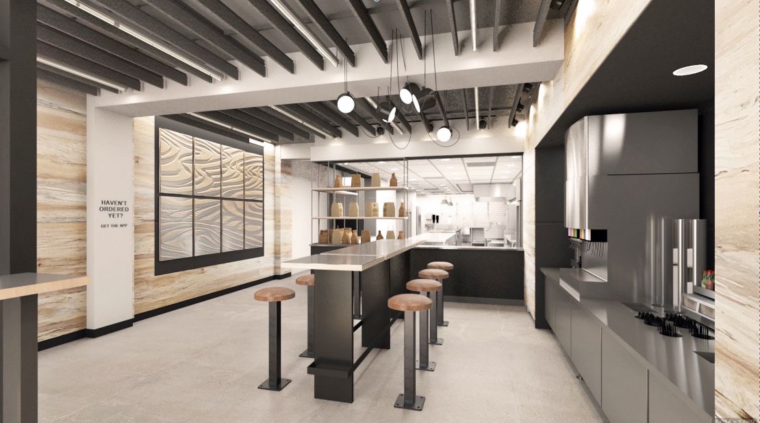 The interior of Chipotle's digital-only restaurant, which has a center table for waiting customers.  