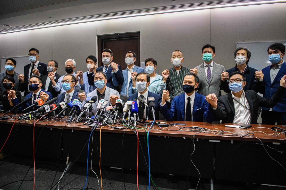 Pro-democracy lawmakers join hands at the start of a press conference in a Legislative Council office in Hong Kong on Wednesday.