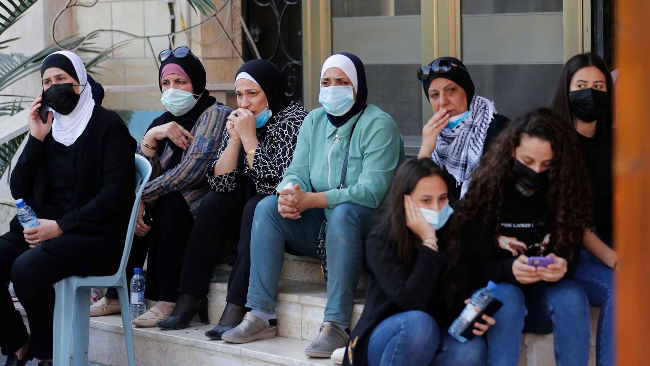 Palestinian mourners wear face masks for the funeral of Saeb Erekat in Jericho on Wednesday.