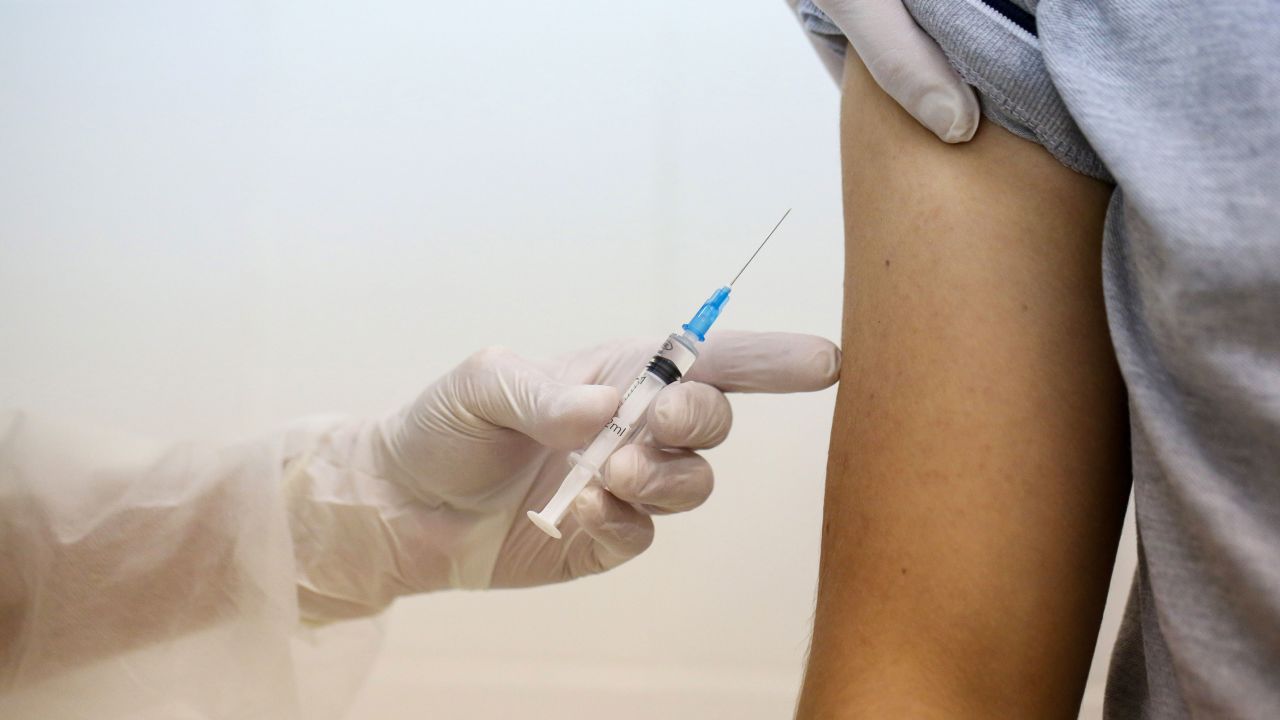 A heath worker prepares to inject the Sputnik V vaccine into a patient's arm during a trial at the City Clinic #46 in Moscow, Russia, on September 23.