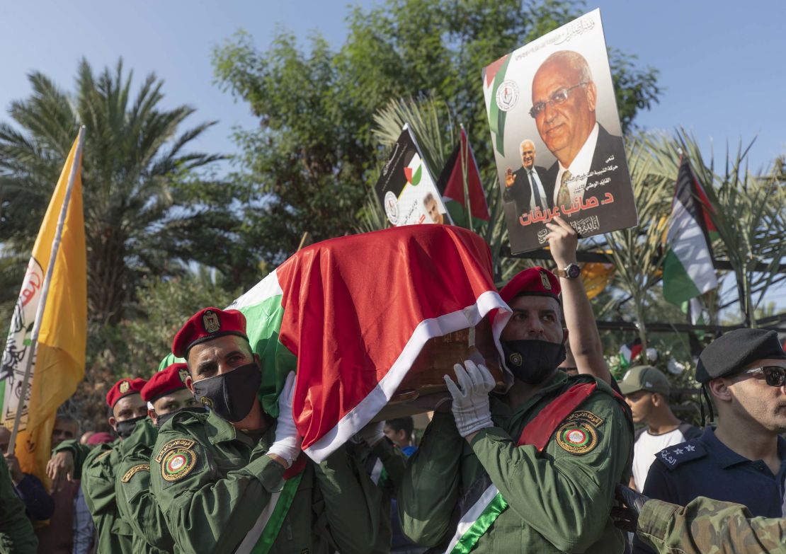 A Palestinian honor guard carries the body of Saeb Erekat into the cemetery in Jericho.