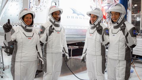 In this Thursday, Sept. 24, 2020, image released by SpaceX/NASA, NASA's SpaceX Crew-1 astronauts, from left, mission specialist Shannon Walker, pilot Victor Glover, and Crew Dragon commander Michael Hopkins, all NASA astronauts, and mission specialist Soichi Noguchi, Japan Aerospace Exploration Agency (JAXA) astronaut, gesture during crew equipment interface testing at SpaceX headquarters in Hawthorne, Calif. SpaceX's second astronaut flight is off until mid-November 2020 because red lacquer dripped into tiny vent holes in two rocket engines that now must be replaced. (SpaceX/NASA via AP)