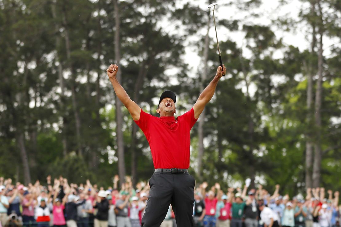 Tiger Woods celebrates after sinking his putt on the 18th green to win the Masters.