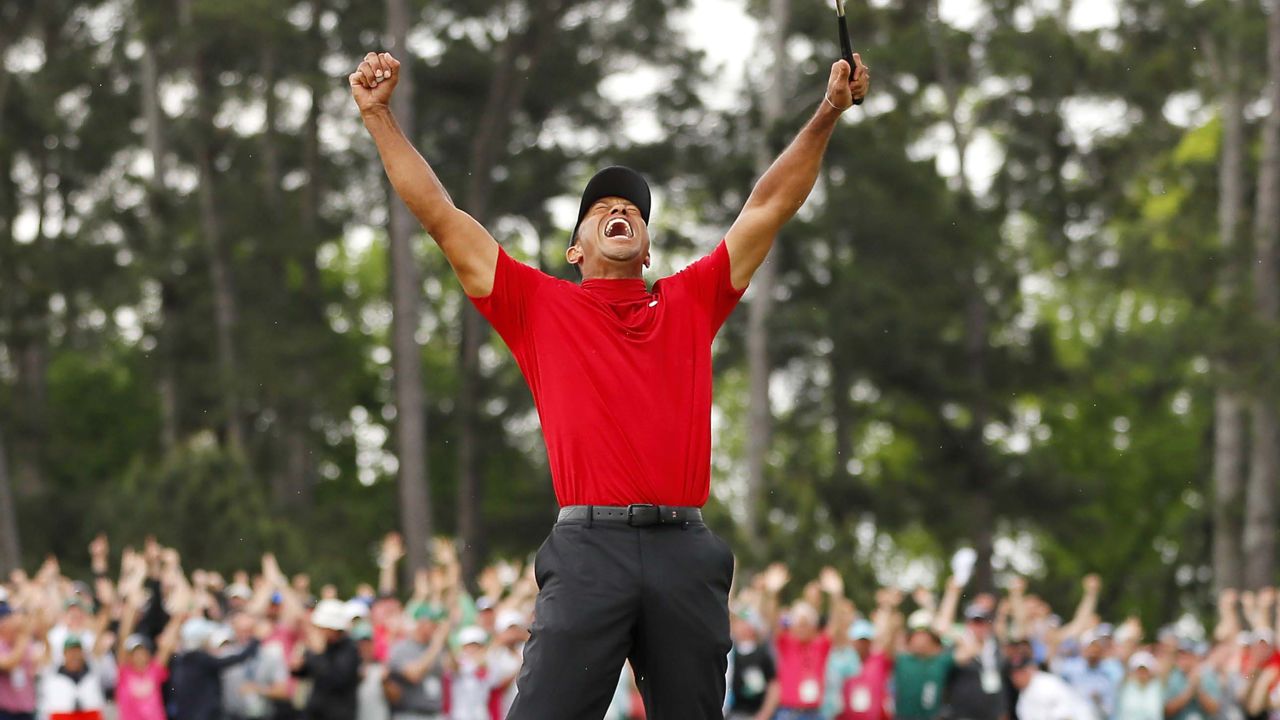 Tiger Woods celebrates after sinking his putt on the 18th green to win the Masters.