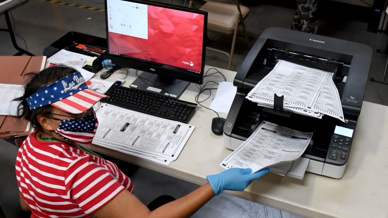 A Clark County election worker scans mail-in ballots at the Clark County Election Department on October 20, 2020 in North Las Vegas, Nevada.