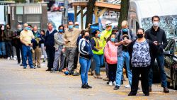 People line up outside a Covid-19 testing site in New York on November 11, 2020. - The novel coronavirus has killed at least 1,275,113 people since the outbreak emerged in China last December, according to a tally from official sources compiled by AFP at 1100 GMT on Wednesday. At least 51,531,660 cases of coronavirus have been registered. Of these, at least 33,300,900 are now considered recovered. (Photo by Kena Betancur / AFP) (Photo by KENA BETANCUR/AFP via Getty Images)