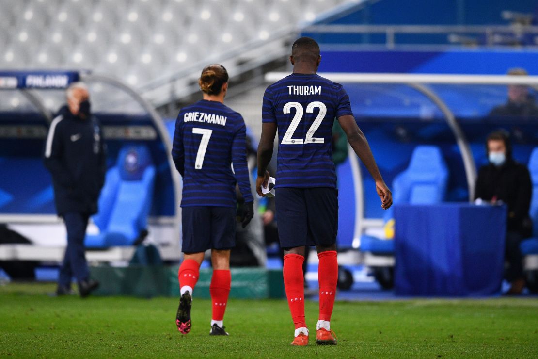 France's Marcus Thuram and Antoine Griezmann leave the field after defeat by Finland. 