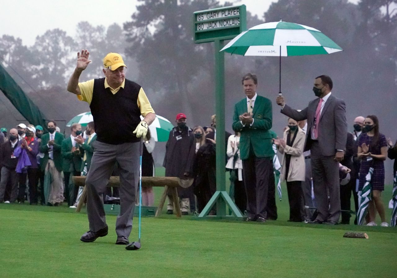 Honorary starter Jack Nicklaus waves to the few patrons gathered for his ceremonial tee shot on the first hole ahead of the first round.