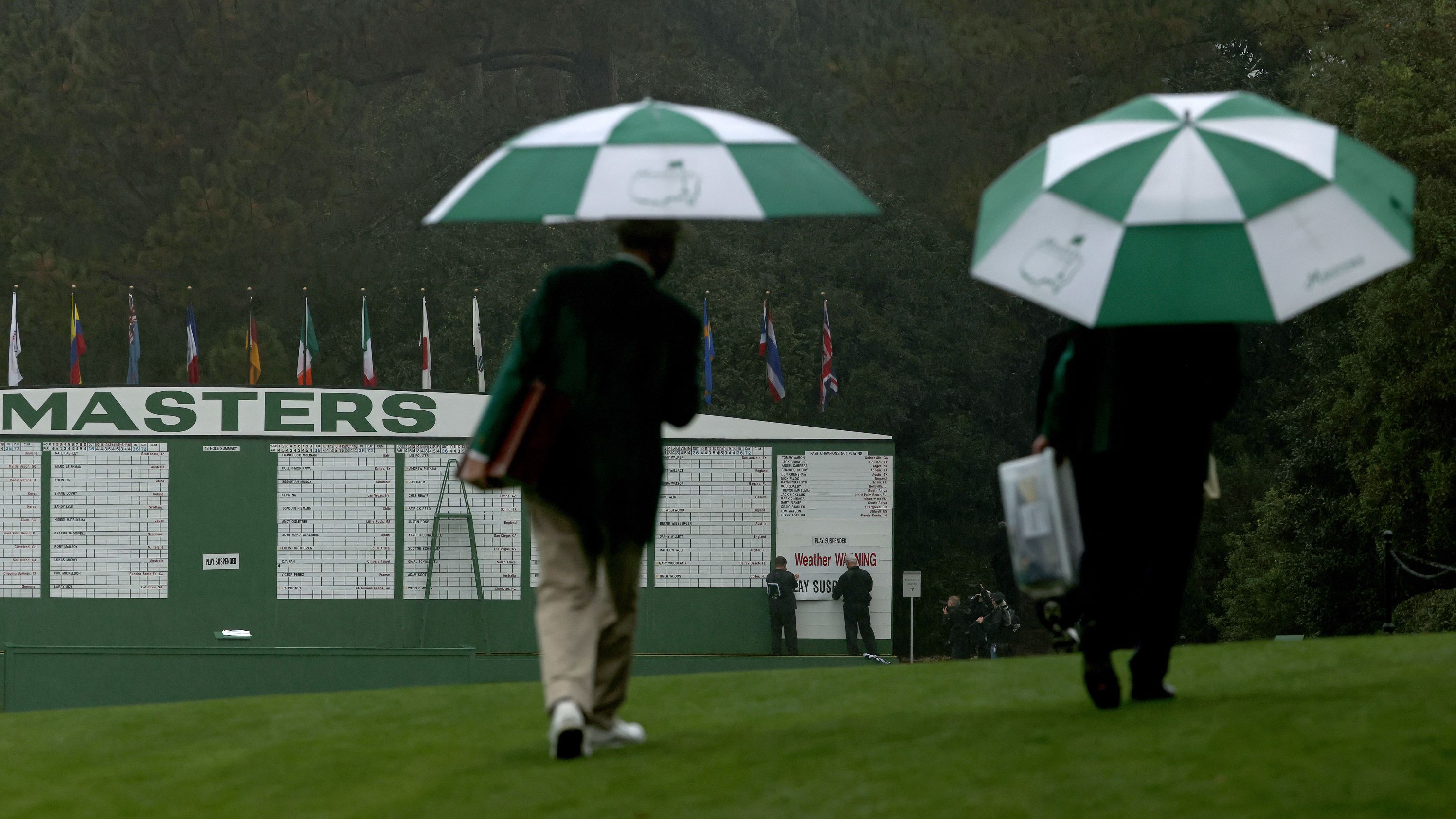 The scoreboard is updated with a "Weather Warning" and "Play Suspended" sign after lightning and rain caused play to be halted after just 30 minutes on the first day.