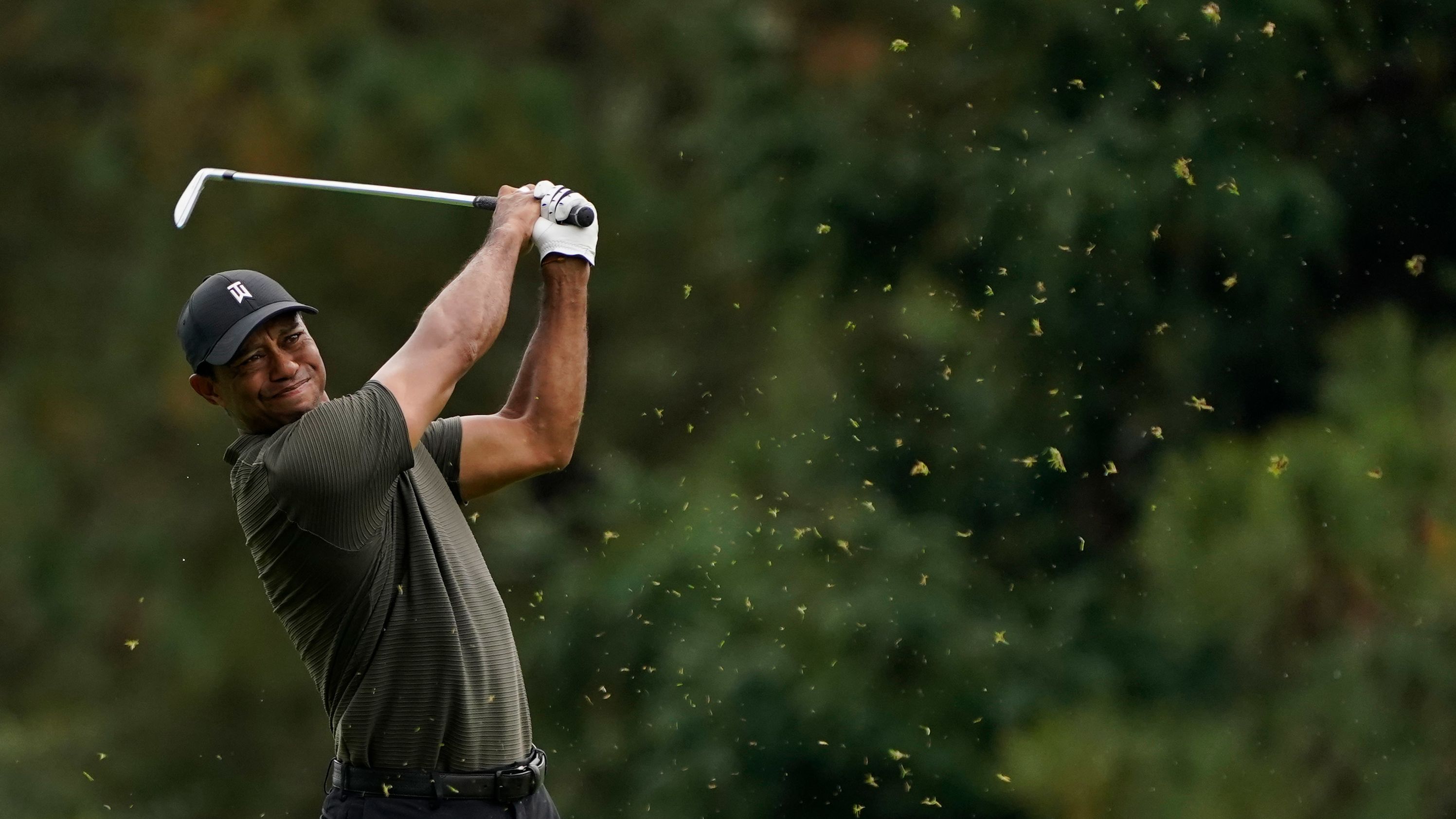 Tiger Woods hits from the 15th fairway during the first round of the Masters. He finished four-under par.