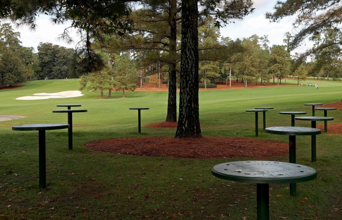 Empty tables are seen near the course during the first round. Patrons have not been allowed to attend the tournament due to the coronavirus pandemic. 