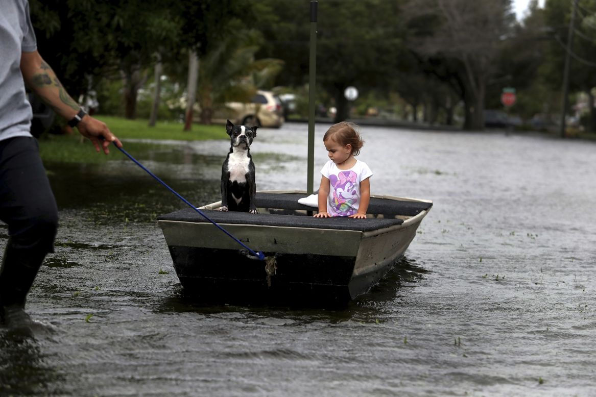 Lemay Acosta pulls his 2-year-old daughter, Layla, and their dog Buster through a flooded neighborhood in Plantation, Florida, on Monday, November 9. It was a day after <a href="https://www.cnn.com/2020/11/09/weather/tropical-storm-eta-monday/index.html" target="_blank">Tropical Storm Eta made landfall.</a>