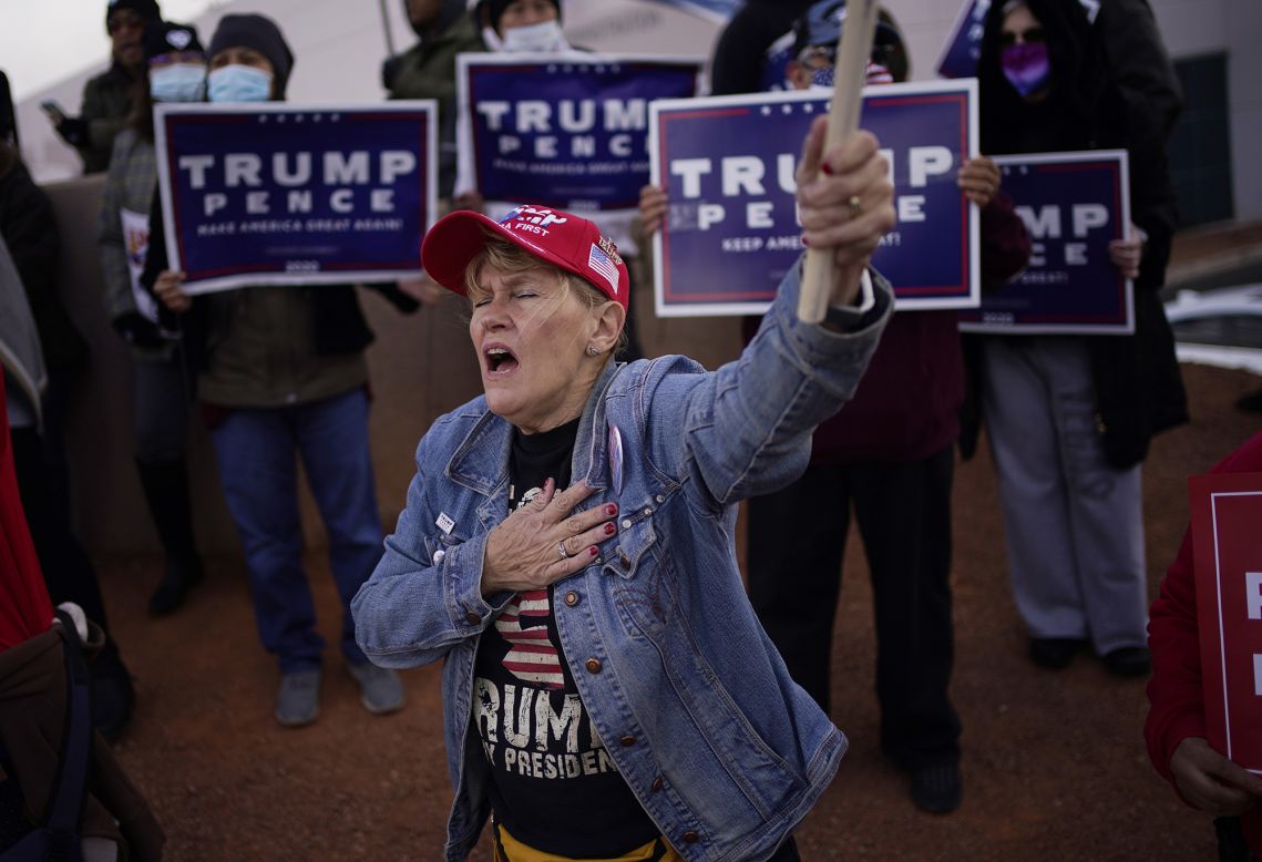 A supporter of US President Donald Trump holds her hand over her heart during a protest outside the Clark County Election Department in North Las Vegas, Nevada, on Sunday, November 8.
