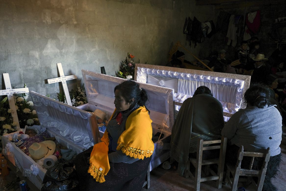 People attend the wake of four family members who died when their home was washed away by flash floods in Mukem, Mexico, on Monday, November 9. The flooding was caused by rains associated with Tropical Storm Eta.