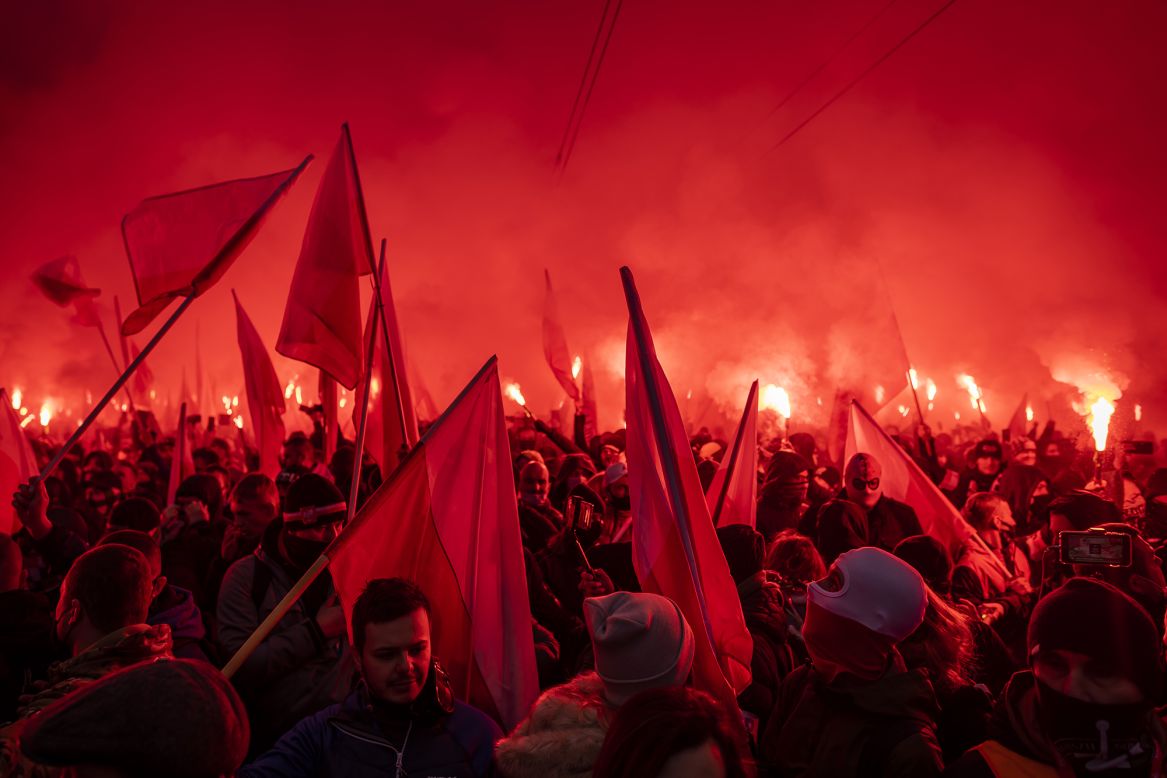 Far-right supporters hold flags and light flares as they march through Warsaw, Poland, to mark the country's Independence Day on Wednesday, November 11.