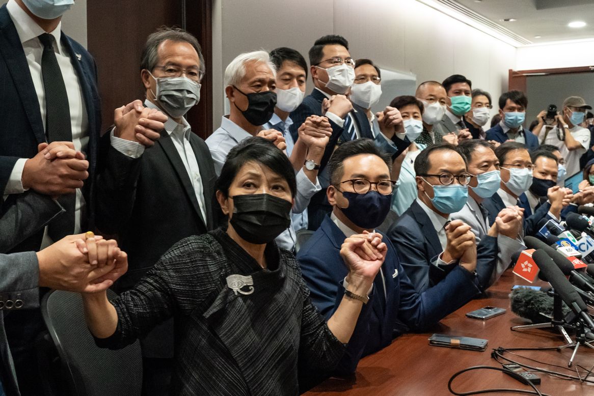 Pro-democracy lawmakers join hands during a news conference in Hong Kong on Wednesday, November 11. The Beijing government passed a resolution allowing Hong Kong authorities to expel locally elected lawmakers without having to go through the courts. Immediately afterward, <a href="https://www.cnn.com/2020/11/12/asia/hong-kong-lawmakers-explainer-intl-hnk-scli/index.html" target="_blank">four pro-democracy lawmakers were ousted from the city's legislature,</a> prompting the entire pan-democrat opposition bloc to announce their intention to resign in protest.