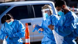 Medical workers put on personal protective equipment (PPE) before starting shifts at a Covid-19 drive-thru testing site in El Paso, Texas, U.S., on Monday, Nov. 9, 2020. Texas recorded more than 9,000 new cases in a 24-hour period last week, the steepest daily increase since Aug. 4, according to state health department figures. Photographer:  via Getty Images