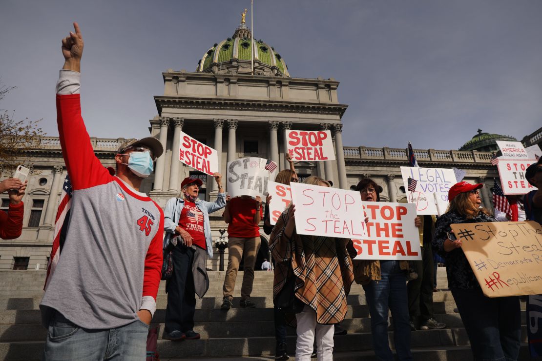 Dozens of people calling for stopping the vote count in Pennsylvania due to alleged fraud against President Donald Trump gather on the steps of the State Capitol on November 5 in Harrisburg, Pennsylvania. 