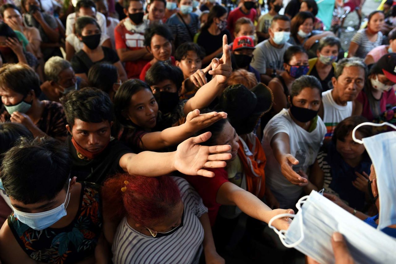 Face masks and relief goods are distributed at an evacuation center in Rodriguez.