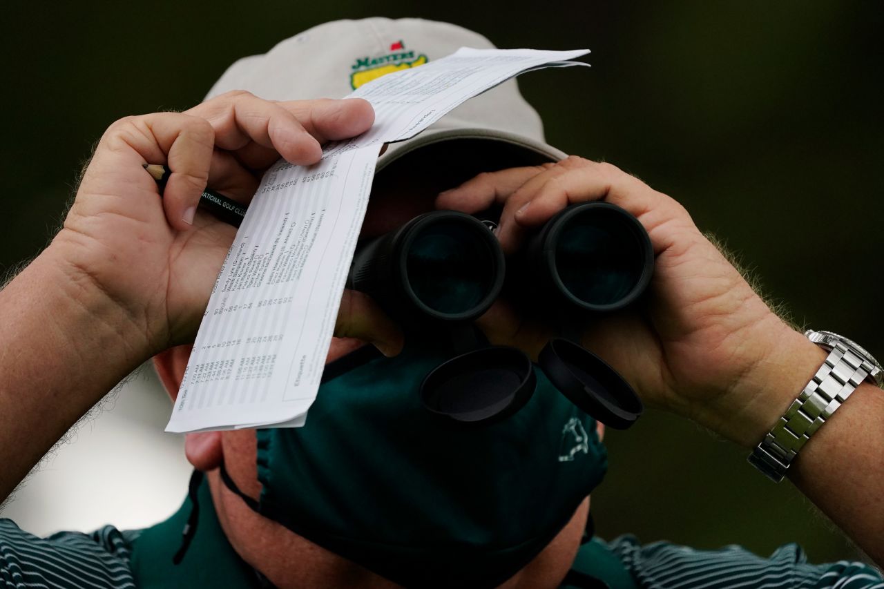 A course worker watches play on the 17th hole during the first round of the Masters golf tournament.