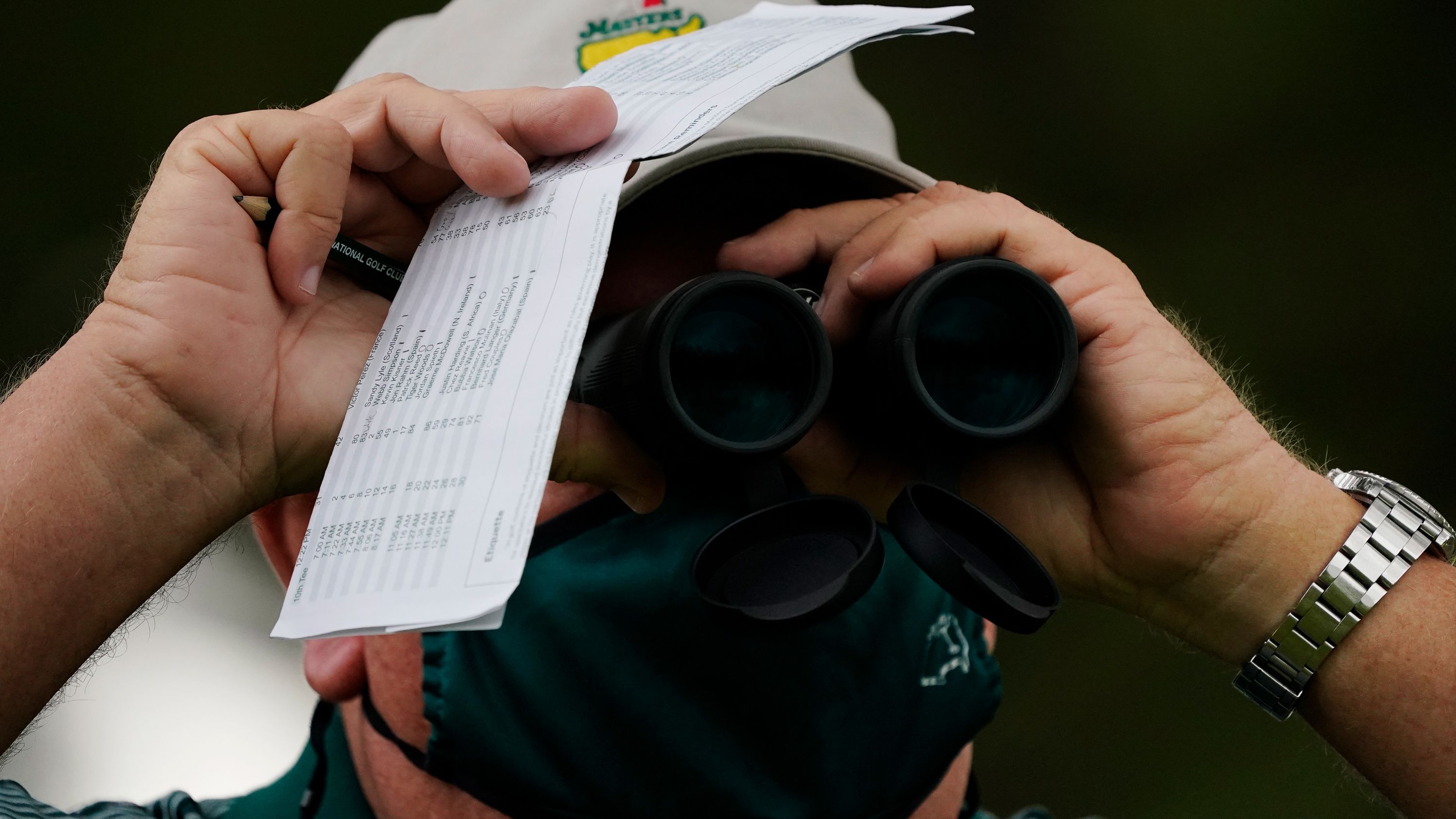 A course worker watches play on the 17th hole during the first round of the Masters golf tournament.