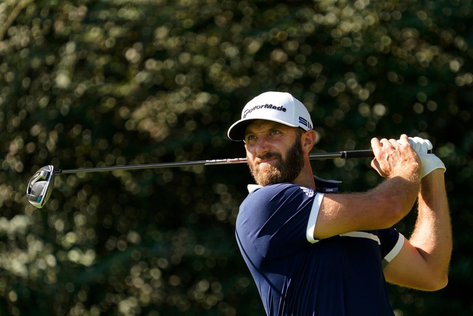 Dustin Johnson watches his tee shot on the 14th hole during the second round on his way to a 70 and the joint clubhouse lead at nine-under.