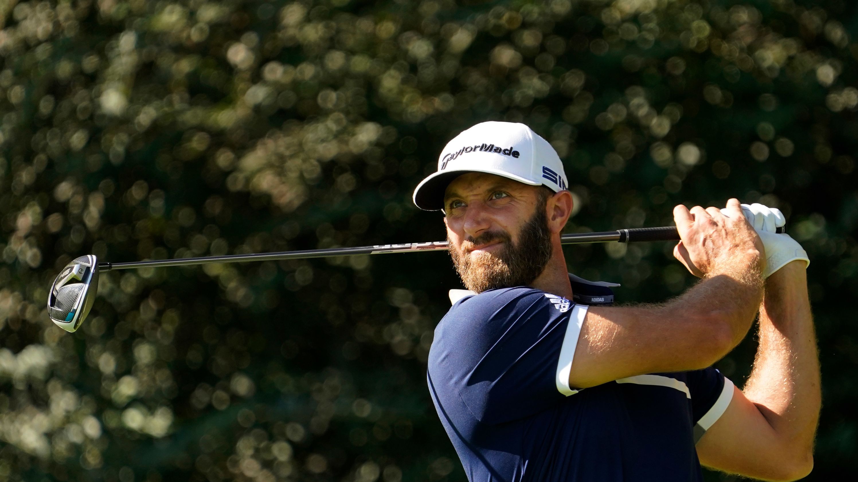 Dustin Johnson watches his tee shot on the 14th hole during the second round on his way to a 70 and the joint clubhouse lead at nine-under.