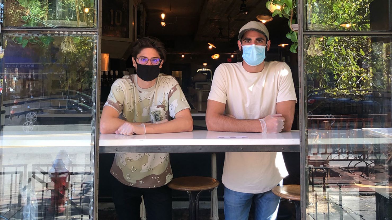 Barbershop owner Andre Fersa (right) and buddy Joe Mercurio get ready to serve at Würstbar in New Jersey City.