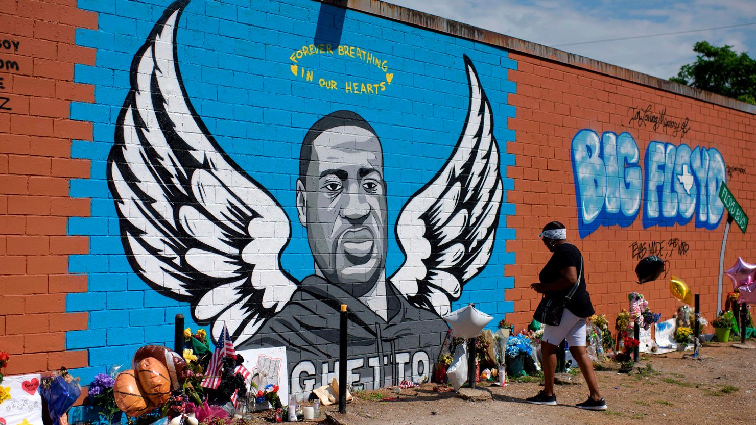 Visitors pay their respects to George Floyd in front of a mural in Houston, Texas. Texas A&M University-Commerce will begin an internship program in Floyd's name next January. 