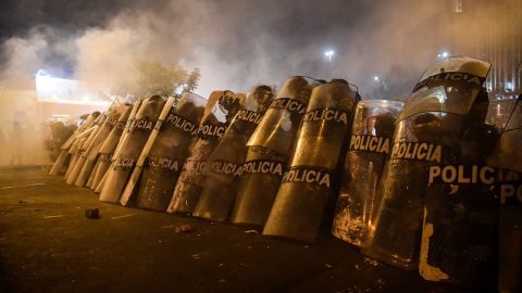 Riot police take positions during protests on November 12.