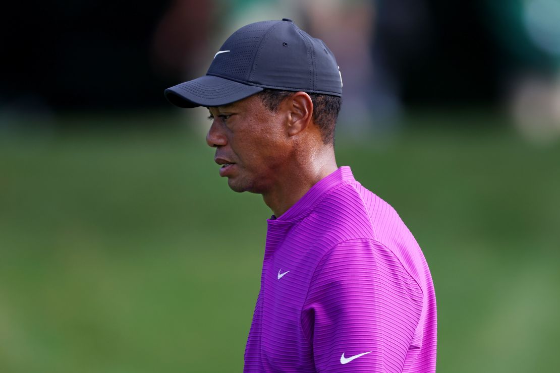 A pensive Tiger Woods walks off the eighth green on his way to a level-par 72 to leave him off the pace in his defense of the title at Augusta.