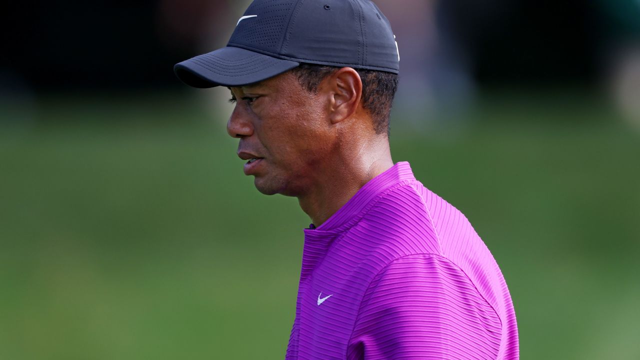 A pensive Tiger Woods walks off the eighth green on his way to a level-par 72 to leave him off the pace in his defense of the title at Augusta.