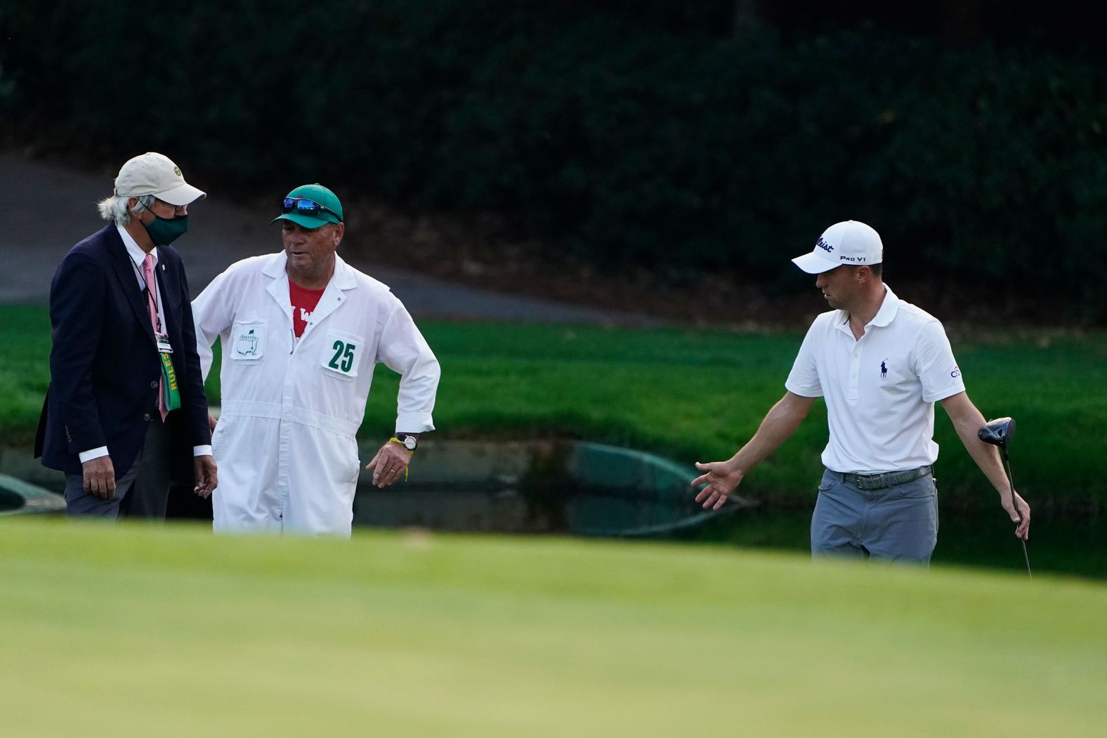 Justin Thomas takes to a rules official after hitting his ball in the water on the 15th hole.