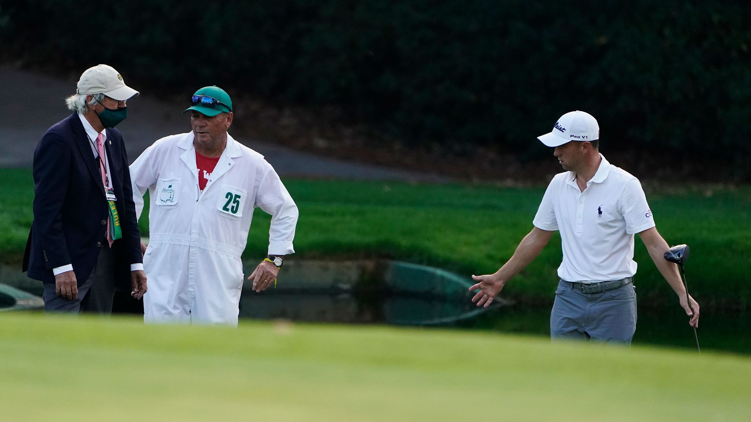 Justin Thomas takes to a rules official after hitting his ball in the water on the 15th hole.