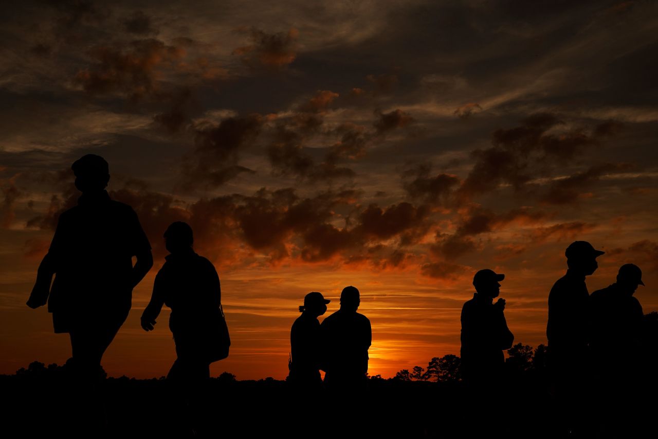Spectators leave the Augusta National Golf Course following the third round.