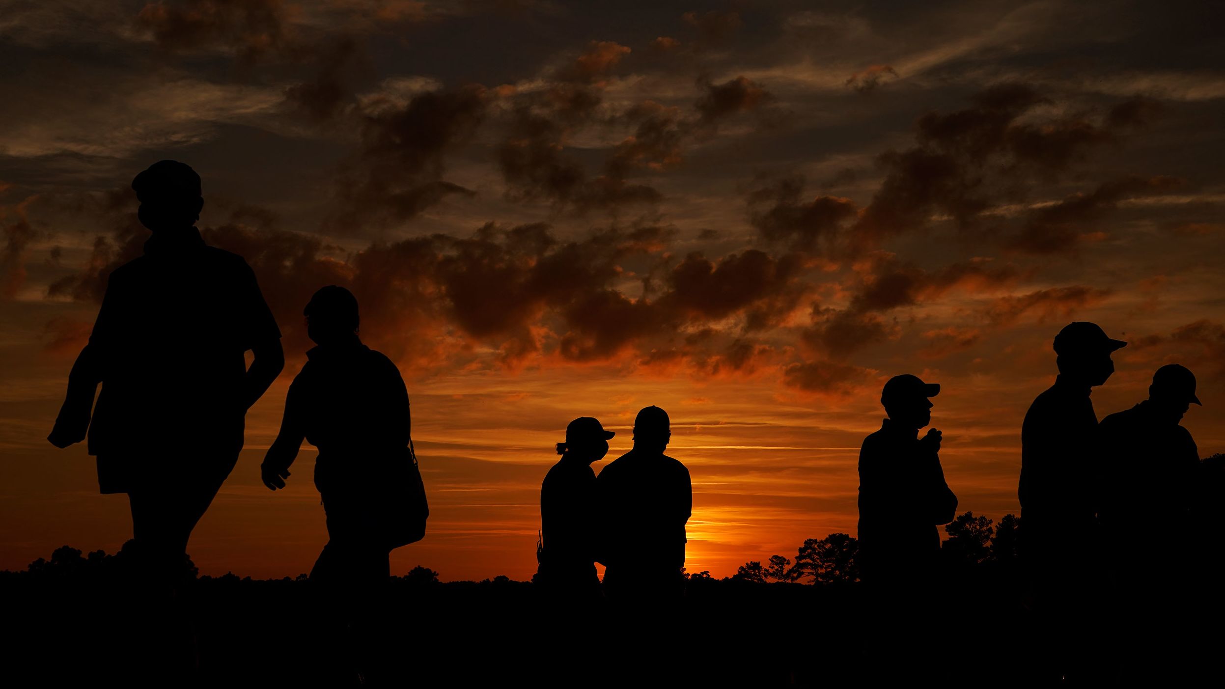 Spectators leave the Augusta National Golf Course following the third round.