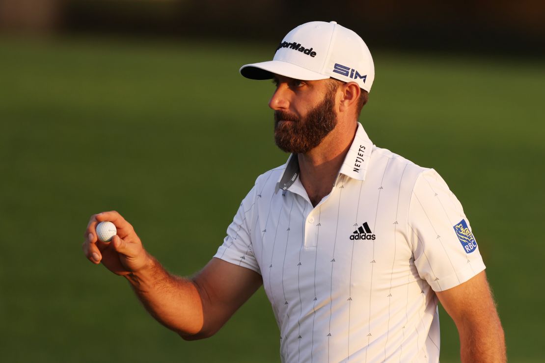 Dustin Johnson closes out his round of 65 by holing a par putt on the 18th at Augusta National to lead the Masters by four shots.