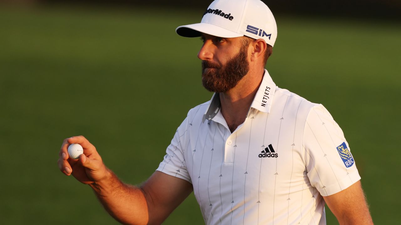Dustin Johnson closes out his round of 65 by holing a par putt on the 18th at Augusta National to lead the Masters by four shots.