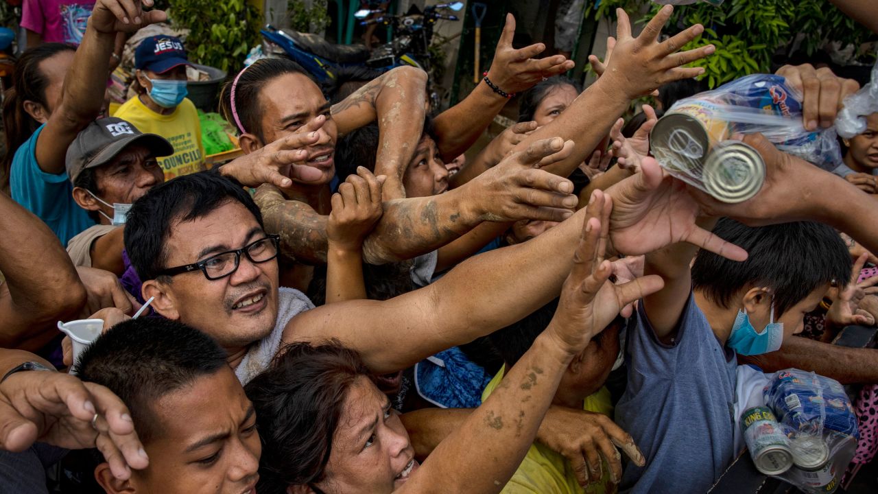 Residents affected by Typhoon Vamco scuffle over relief goods on November 14, 2020 in Rodriguez, Rizal province, Philippines.