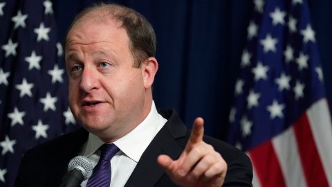 Colorado Gov. Jared Polis makes a point during a news conference about the state's rapid increase in coronavirus cases in Denver on Friday, Nov. 13, 2020.