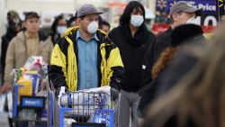 UNIONDALE, NEW YORK - APRIL 03:  People wearing masks and gloves wait to checkout at Walmart on April 03, 2020 in Uniondale, New York. The World Health Organization declared coronavirus (COVID-19) a global pandemic on March 11th.  (Photo by Al Bello/Getty Images)
